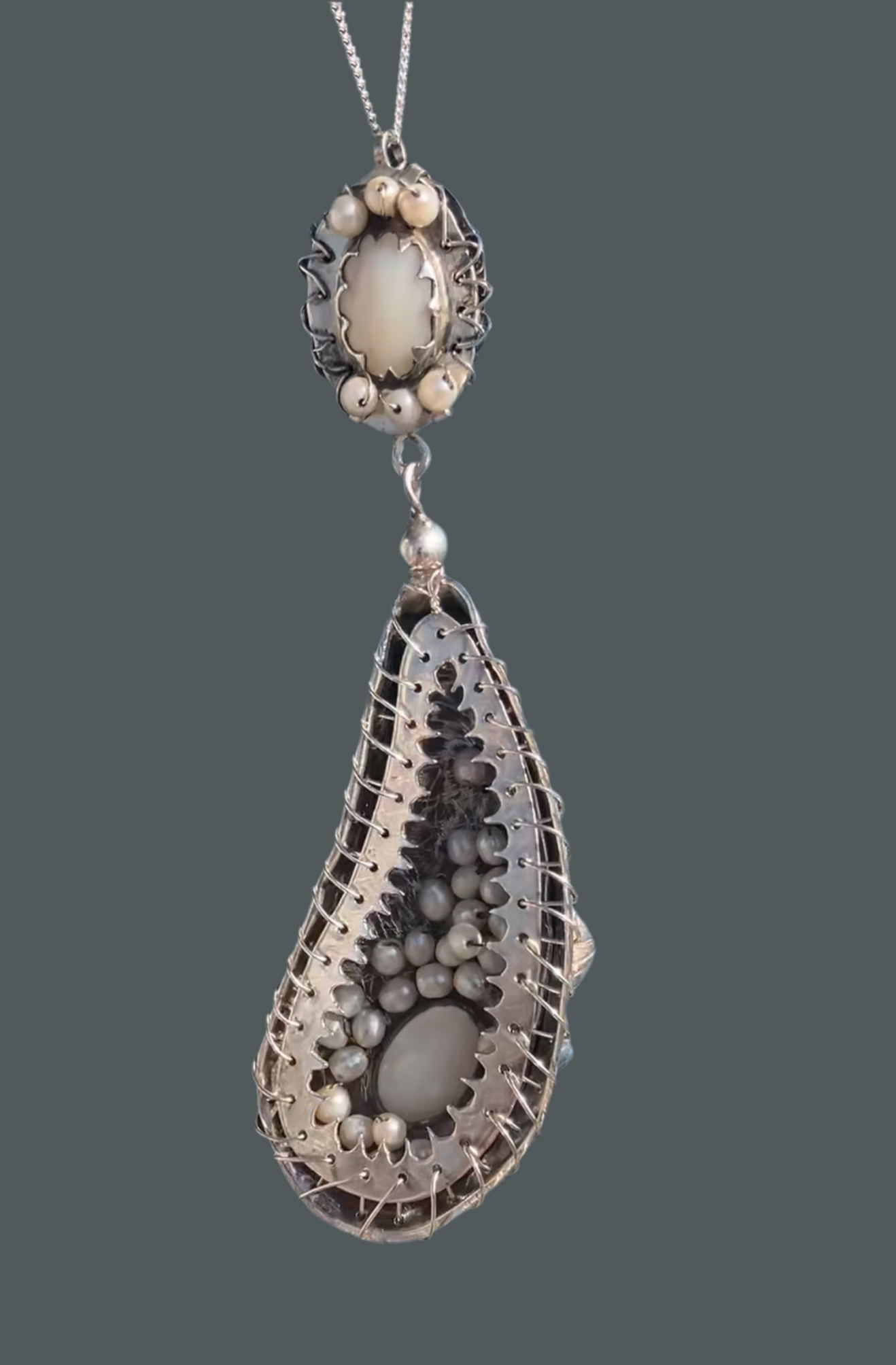 Silver mussel shell pendant with pearls sewn inside