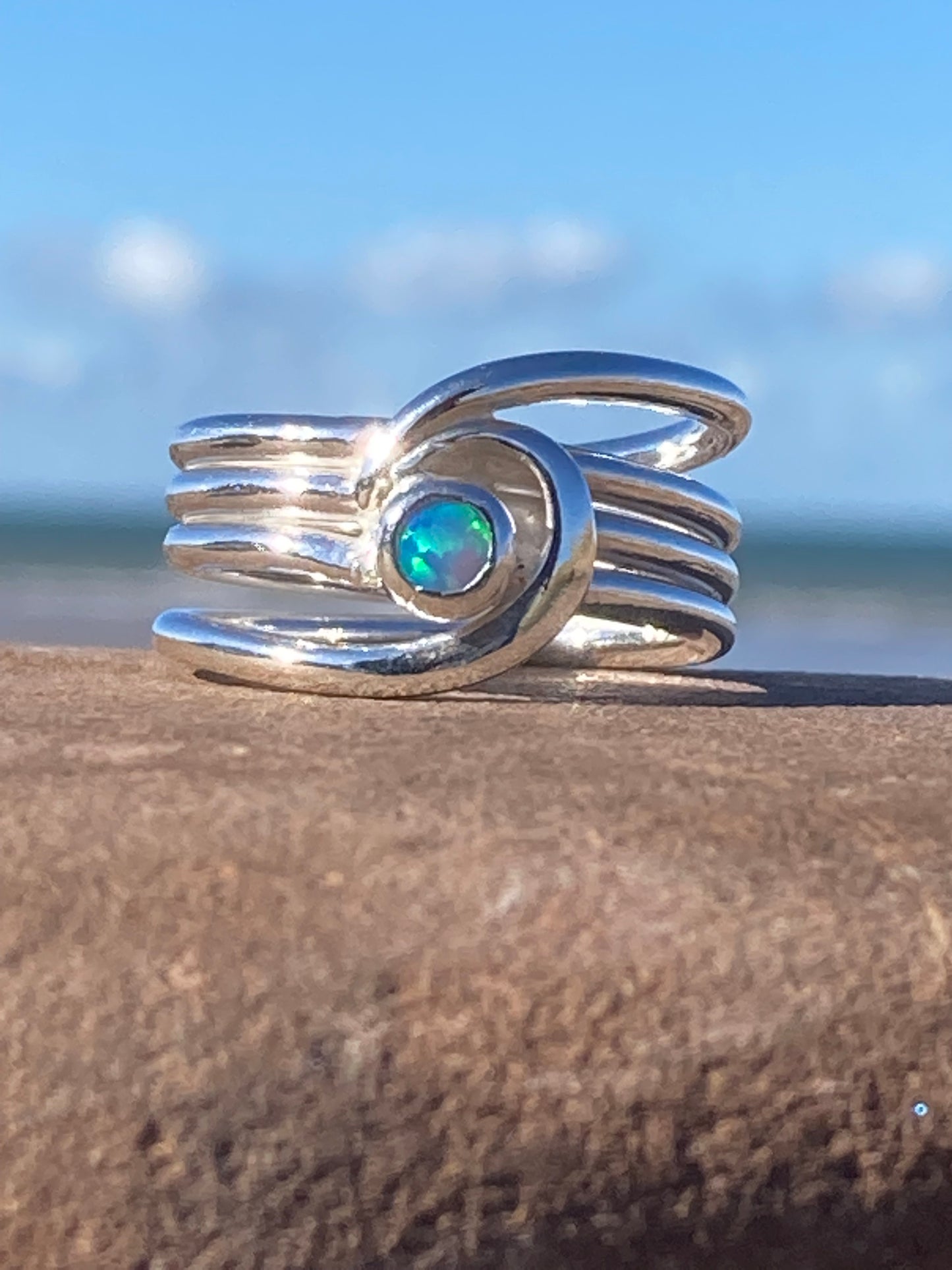 Silver barrelling wave and opal ring