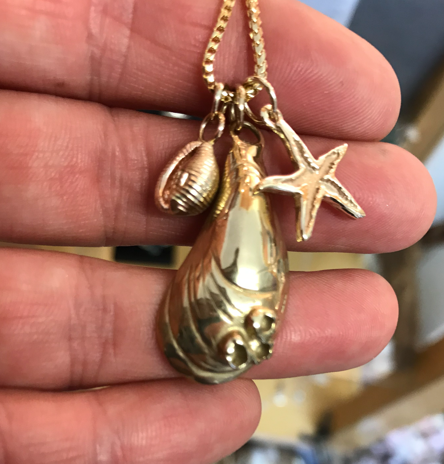 Gold mussel, starfish and cowrie necklace